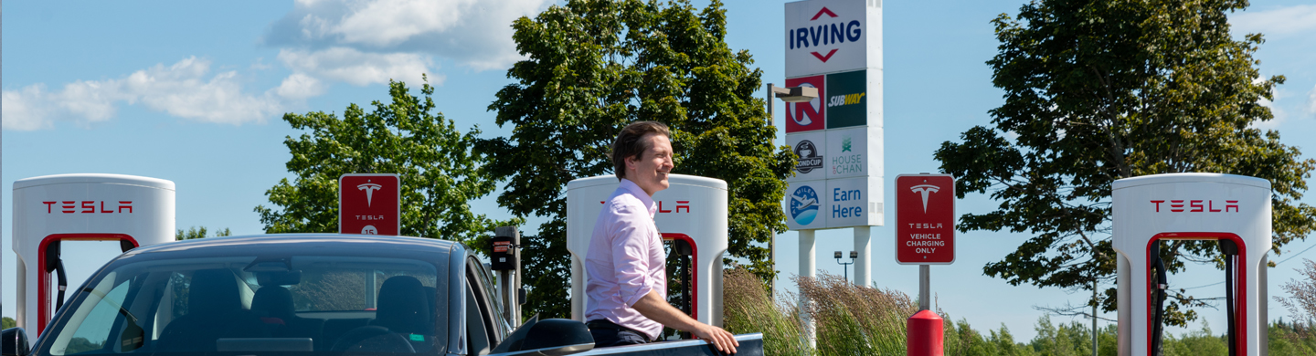 Charging a Tesla at an Irving Oil charging station