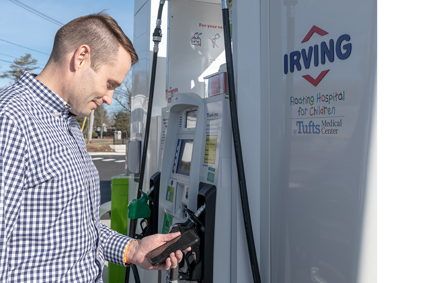 A guy using the pump at the Irving gas station